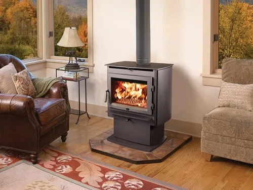 Lopi Evergreen Hybrid Wood Stove, a freestanding wood-burning stove with a glass door and a lit fire visible