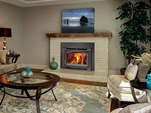 Lopi Large Flushwood Arched Hybrid Wood Insert, a wood-burning fireplace insert with a glass door, installed in a fireplace surround with a lit fire visible