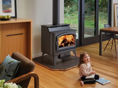 Lopi Liberty Hybrid Wood Stove, a freestanding wood-burning stove with a glass door and a lit fire visible